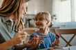 © La Famiglia - Mom and daughter working together to make beautifully decorated Easter eggs