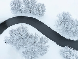 Poster - aerial view of winding road after snow