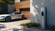 Generic electric vehicle EV hybrid car is being charged from wall charger on contemporary modern residential building house