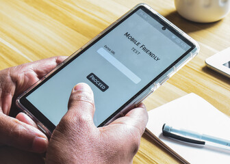 Person using mobile friendly test to analyze the look and performance of his website on the smartphone.