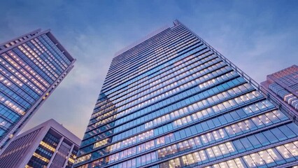 Wall Mural - Twilight sky time lapse view looking up at modern office building. Business, corporate and finance concept.