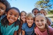 © Adriana - Group of diverse cheerful fun happy multiethnic children outdoors at the schoolyard