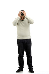 Canvas Print - A man, full-length, on a white background, clutched his head