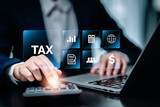 Fototapeta  - E-Filing, E-TAX, Taxpayer using a laptop to file taxes personal income, Tax Return form online for tax payment. Government, state taxes. Data analysis, paperwork, reports. Calculation tax return.