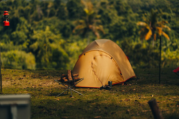 a tent on the grass with a view of the mountains in the background and sunlight. holiday, travel, lo