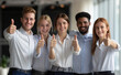 © Curioso.Photography - Thumbs-Up Team: Diverse Employees Recommend Quality Service