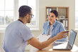© Studio Romantic - Dedicated doctor or nurse, leverages modern technology, including a laptop, during a positive and comprehensive medical healthcare consultation with a patient in a hospital setting.