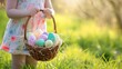 A kid holding a basket full of colorful easter eggs in the meadow, holiday