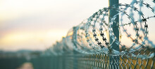 Barbed Wire And Barbed Wire Fence To Prevent Intruders, Anti-refugee Group Entering Wall, In Control Facility, Prison Security Concept.