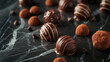 Gourmet chocolate truffles on a dark marble 