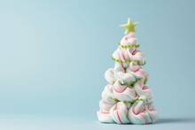 This Is A Creative Photo Of A Stack Of Different Sized Marshmallows In The Shape Of A Christmas Tree Swirled With Green Garland Icing Decoration And A Star On Top 