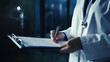 © Yuwarin - Doctors hand holding a medical report in hospital