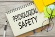 bright stickers and glasses on the table. text Psychological Safety
