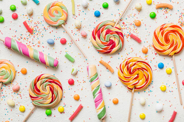 Poster - Tasty appetizing Party Accessories Happy Birthday Sweet. Different types of candies on colored background, copy space. Colorful birthday party background