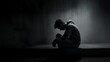 Silent Sorrow-AI-generated image portrays a man seated in solitude, his head bowed in contemplation or sorrow. The dramatic interplay of light and shadow captures a moment of personal anguish or deep 