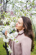 © Oksana Klymenko - Healthy happy woman on spring outdoors. Smiling young woman on the spring garden enjoy blooming flowers of tree. Enjoy Nature. No allergy.