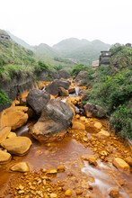 River With Big Yellow Rocks And Amazing Golden Color Stream In Jinguashi, New Taipei City