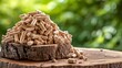 Biomass wood pellets pile and woodpile on blurred background with copy space for text placement