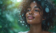 A beautiful young African American woman with curly hair enjoys a rain shower in the forest. Happy young woman in raindrops. Gorgeous lady under rain with beautiful rain. Summer rain.