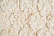 Round puffed crispy rice crackers on a white background.	