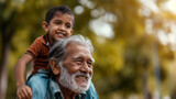 Fototapeta  - Senior man joyfully carrying his grandson on shoulders at an Indian park, creating special memories