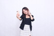 © Ajab - beautiful Indonesian office girl in her 20s, cheerful expression okay, looking at her cream colored cellphone gadget while making a video call for a promo isolated on a white background