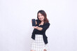 © Ajab - beautiful Indonesian office woman 20s cheerful smile expression promotion cellphone gadget screen hand welcome forward for promo isolated white background