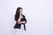 © Ajab - the charm of a beautiful Asian office woman in her 20s flat expression is on the phone using a cellphone gadget for promos while holding her arms to the left isolated on a white background