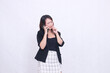 © Ajab - the charm of a beautiful Asian office woman in her 20s with a bitter expression while making a phone call on a cell phone while holding her hand to her mouth isolated on a white background