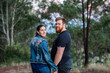 © Austockphoto - happy young married couple holding hands while on a walk through bushland