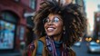 © Daniela - Portrait of a smiling young pretty african american woman wearing glasses in the city.