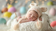© Chanakan - A peaceful newborn baby sleeps in a bunny hat, surrounded by colorful Easter eggs.