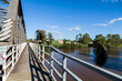 © Austockphoto - Footpath on side of bridge overlooking brown floodwaters or raging river