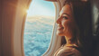 A beautiful woman sits on an airplane by the window and looks at the view. Tourist travel by plane background