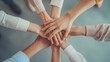 © phairot - Team Unity Displayed Through Hand Stack in Office. A diverse office team showcases unity and teamwork with a collective hand stack over a meeting table.