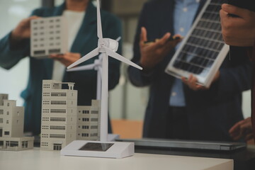 Poster - Close-up at tablet, Engineers pointing at tablet with their hands. To jointly design the use of renewable energy with wind and solar energy. Concept of using renewable energy.