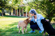 © Austockphoto - Middle aged woman training dogs outside