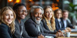 © aekkorn - Smiling group of diverse businesspeople working together around a meeting table in an office complex lobby.