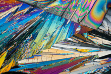 Vivid Microscopic View Of Erythritol Sugar Crystals Displaying A Kaleidoscope Of Colors With Angular Shapes And Patterns