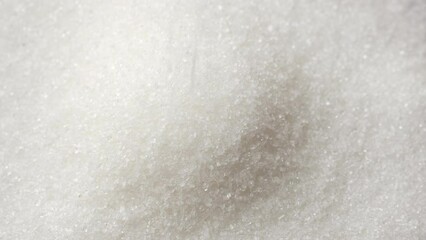 Sticker - White sugar falling down on heap, close up