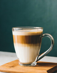 Wall Mural - Coffee latte in a glass cup on dark background