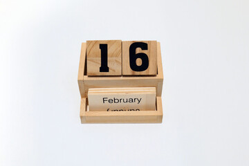 16th of February wooden perpetual calendar. Shot close up isolated on a white background