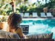 © CG Design - A person participating in a virtual meeting from a poolside lounge