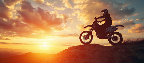 Wall Mural - Motorcyclist riding on mountain at sunset