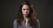 © Михайло Пеленський - Photograph of a woman with long straight brown hair standing with an angry expression on her face.