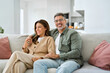 © insta_photos - Happy middle aged mature romantic couple in their 40s hugging sitting on couch at home. Smiling older man and woman in love relaxing on sofa together enjoying chilling in modern house living room.