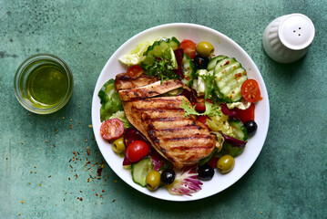 Wall Mural - Grilled chicken fillet with fresh vegetable salad. Top view with copy space.