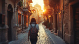Fototapeta Uliczki - A lone traveler, backpack slung over their shoulder, wandering through the narrow, cobblestone streets of an ancient city, with historic buildings towering on either side and the warm