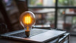 Luminous Creativity: Glowing Light Bulb on Laptop in Idea Wonderland