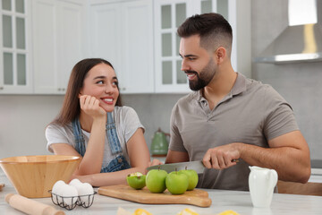 Canvas Print - Happy young couple spending time together in kitchen